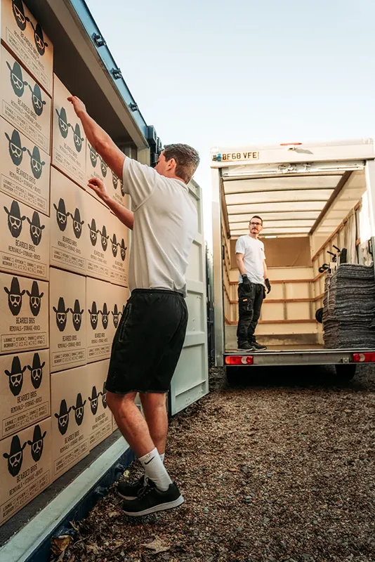 Bearded Bros team loading branded boxes into self-storage container at Springfield Road, Brighton