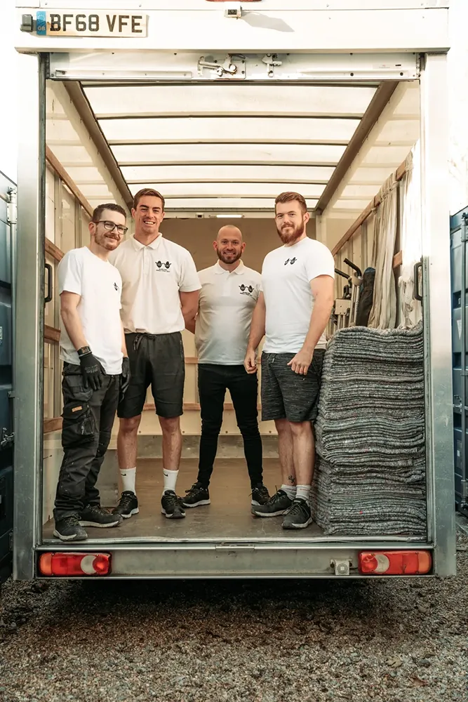 Four Bearded Bros crew members standing at the back of an open branded van