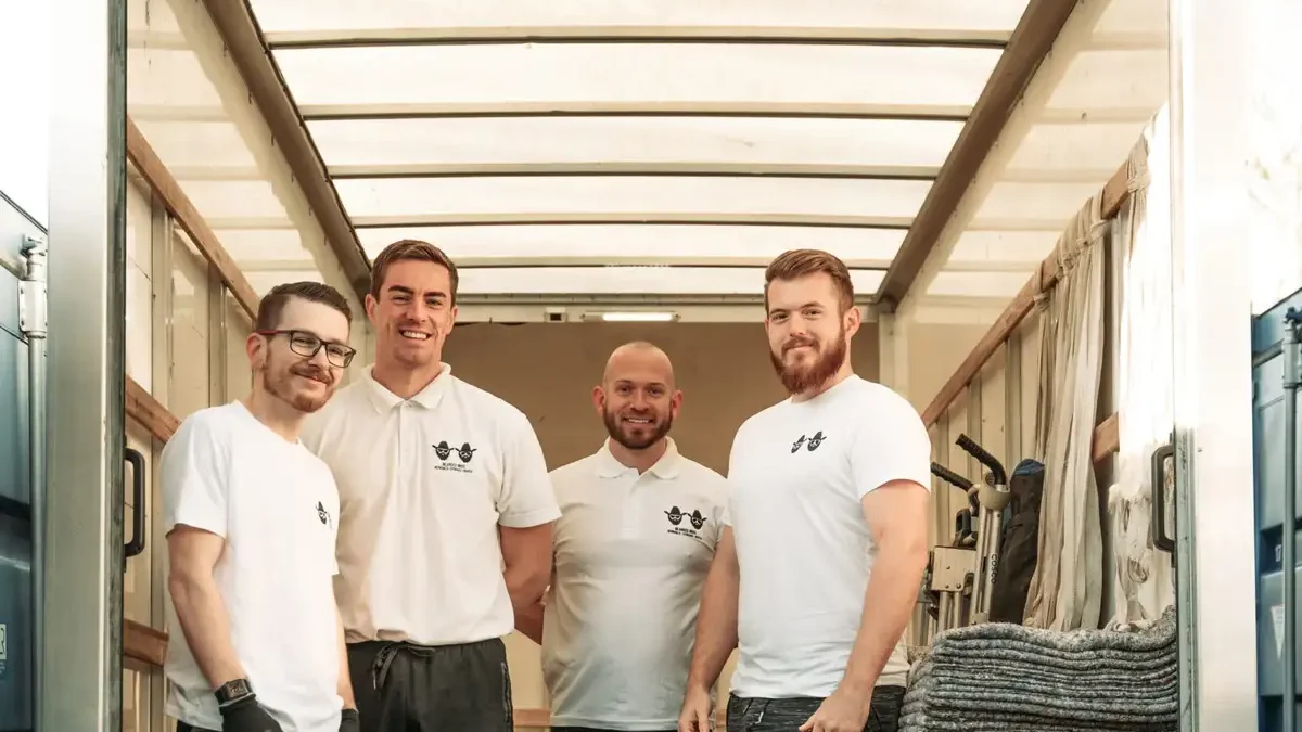 Four Bearded Bros crew members standing at the back of an open branded van