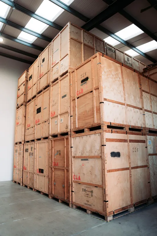 Rows of stacked wooden storage crates in Bearded Bros warehouse