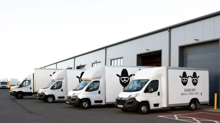 Bearded Bros branded removals van fleet parked outside the Brighton depot