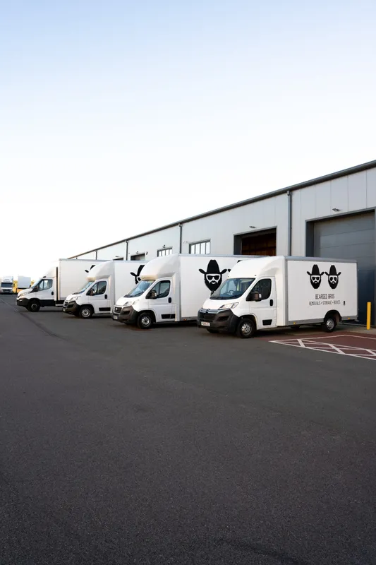 Bearded Bros branded removals van fleet parked outside the Brighton depot
