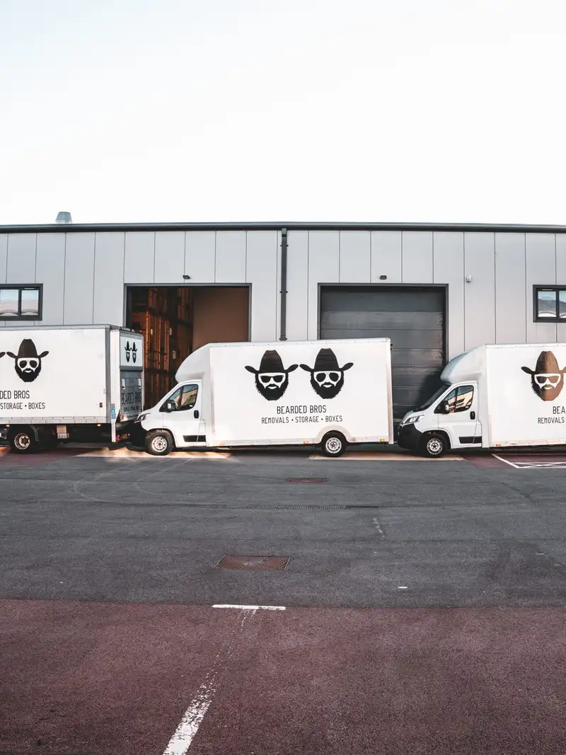 Bearded Bros van fleet parked outside the storage warehouse, ready to load