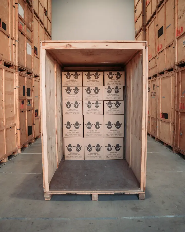 Bearded Bros branded boxes packed into a wooden storage crate