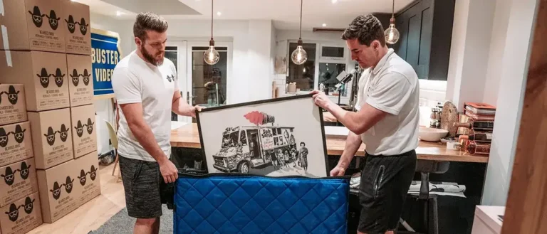 Bearded Bros mover wrapping a framed picture in protective paper