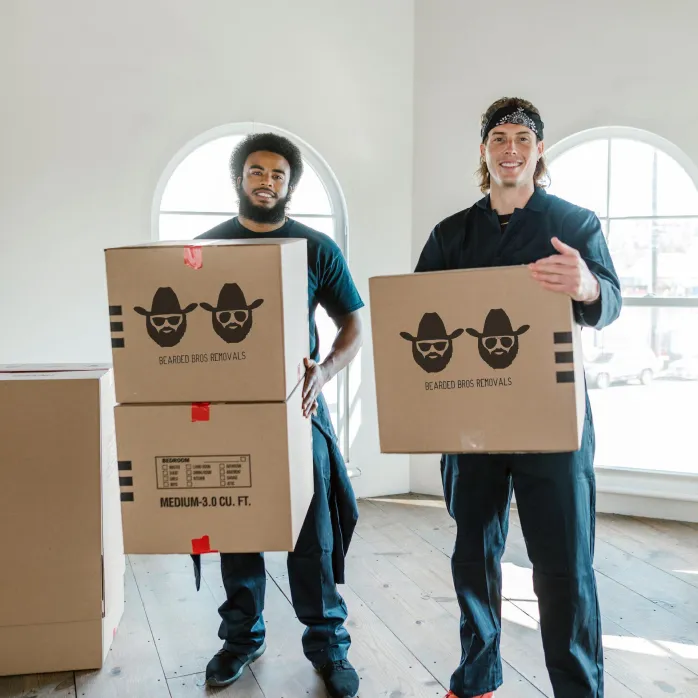 Bearded Bros movers holding branded boxes during an office move