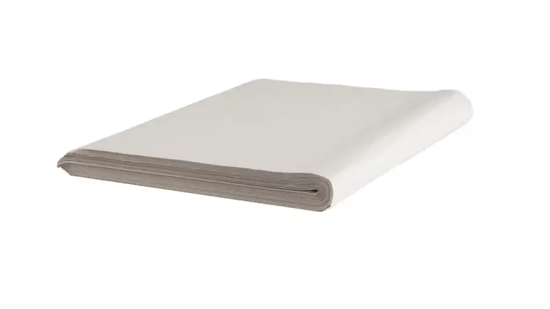 Folded stack of white protective packing paper on a plain background