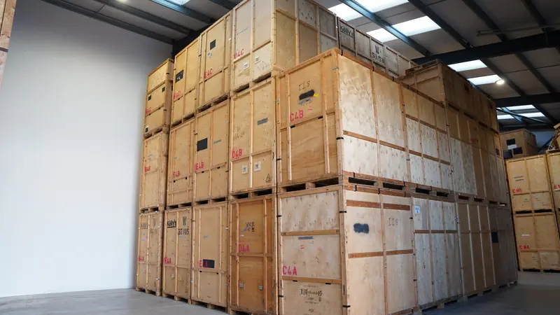 Wooden storage crates stacked floor to ceiling in the Bearded Bros storage warehouse, wide view